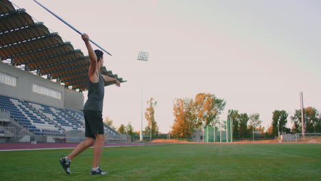 Slow-motion:-a-Male-athlete-at-the-stadium-concentrates-runs-up-and-throws-a-javelin.-Preparation-for-the-Olympic-games-all-around